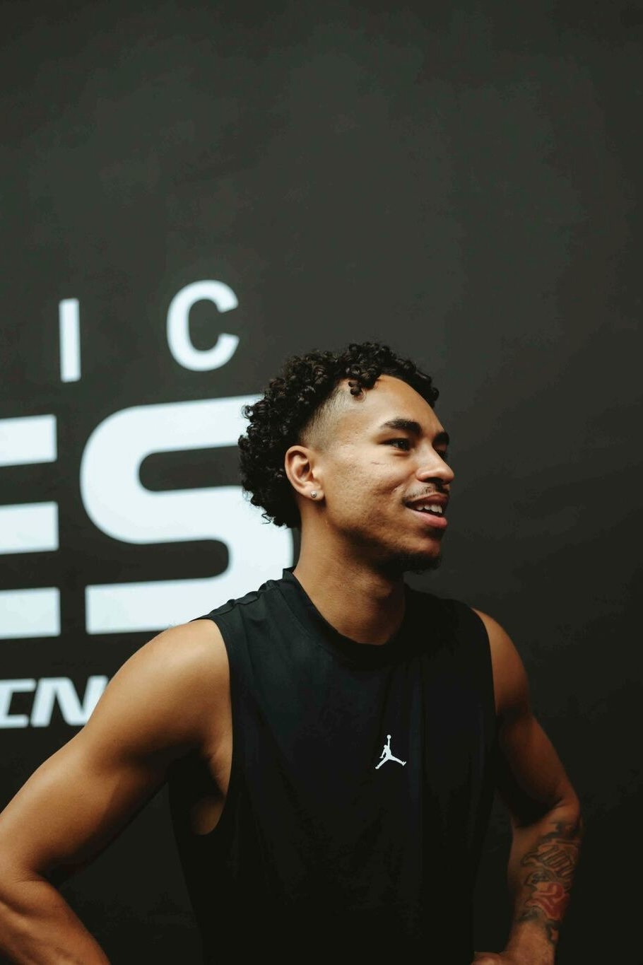 Jayo smiling in a black Jordan tank