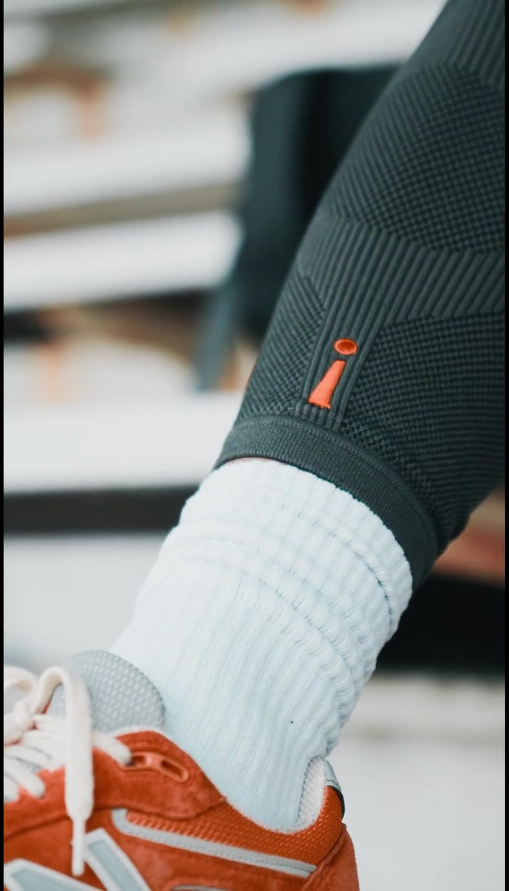 Close-up of the Incrediwear leg sleeve above an orange sneaker
