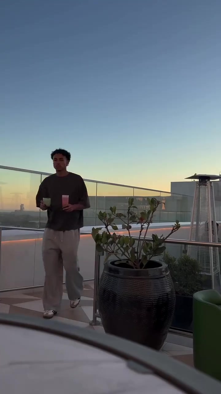 Jayo on a rooftop terrace at sunset